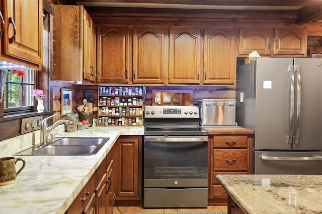 7261 Kingston Rd, Fairview, TN 37062 - kitchen with appliances with stainless steel finishes, a sink, brown cabinetry, and light stone counters