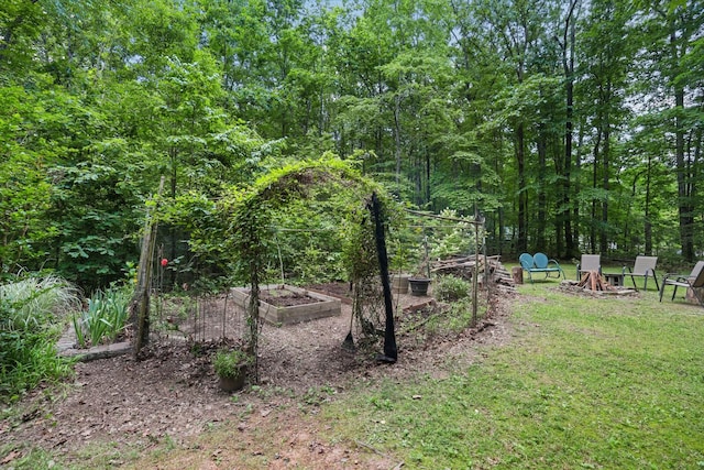 7261 Kingston Rd, Fairview, TN 37062 - view of green lawn featuring a garden and an outdoor fire pit