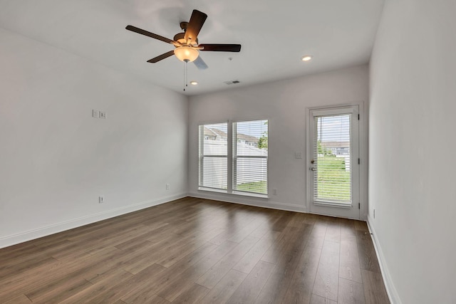 spare room featuring baseboards, dark wood-type flooring, recessed lighting, and ceiling fan
