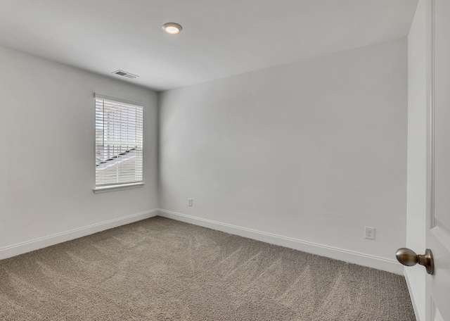 carpeted empty room with baseboards