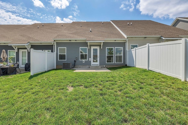 back of house with a patio area, central air condition unit, and roof with shingles