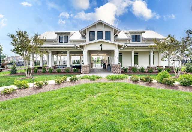 view of front facade featuring a front yard, a porch, and brick siding