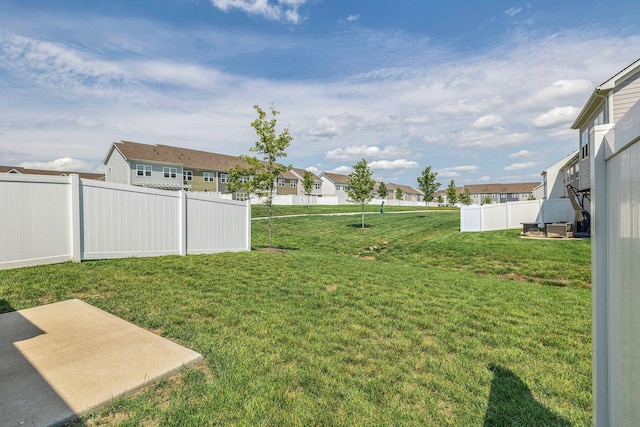 view of yard with a residential view and a patio area