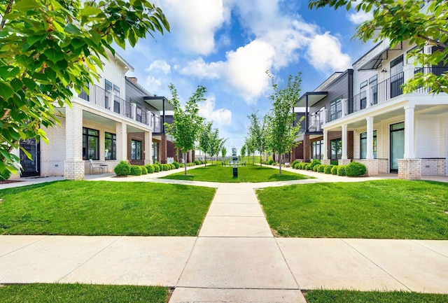 surrounding community featuring a lawn and a residential view