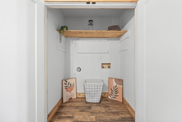 laundry room with hookup for a washing machine, wood finished floors, and baseboards