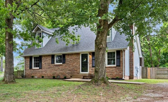 cape cod house with brick siding, crawl space, and roof with shingles