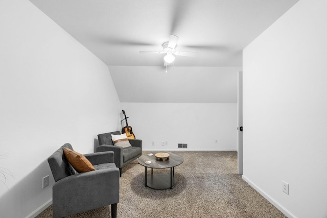 living area featuring a ceiling fan, carpet flooring, baseboards, and vaulted ceiling