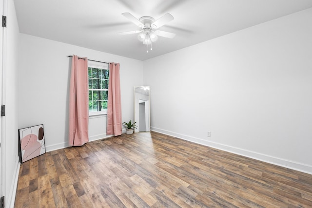 unfurnished room featuring wood finished floors, ceiling fan, and baseboards