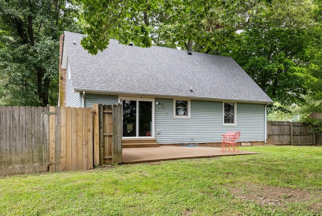 back of property with a patio area and a shingled roof