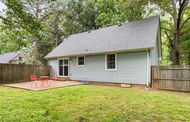 back of property with a patio area and roof with shingles
