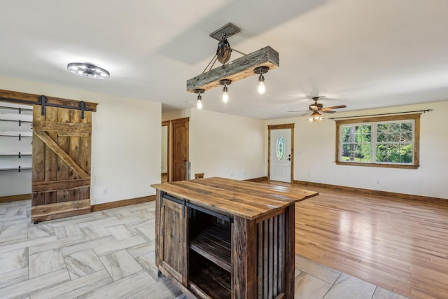 46 Seay Ln, Erin, TN 37061 - kitchen featuring butcher block counters, baseboards, a barn door, and ceiling fan