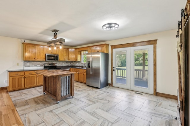 46 Seay Ln, Erin, TN 37061 - kitchen with appliances with stainless steel finishes, baseboards, butcher block countertops, and a sink
