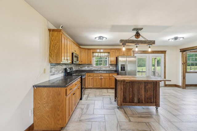 46 Seay Ln, Erin, TN 37061 - kitchen with appliances with stainless steel finishes, a sink, healthy amount of natural light, and decorative backsplash
