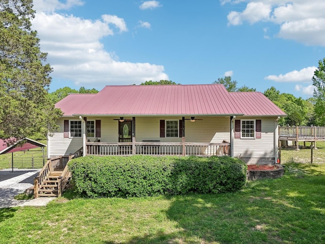 46 Seay Ln, Erin, TN 37061 - ranch-style home featuring ceiling fan, a front yard, metal roof, and stairs