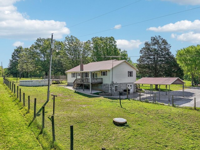 46 Seay Ln, Erin, TN 37061 - back of property with a carport and view of wooded area
