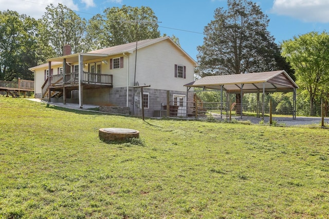 46 Seay Ln, Erin, TN 37061 - back of house featuring a chimney, a carport, a wooden deck, and a yard