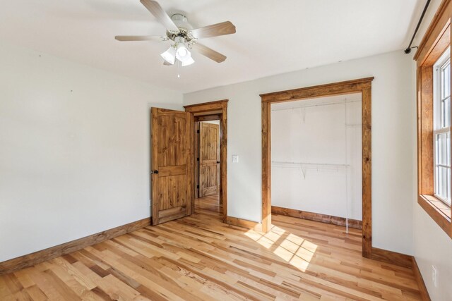 46 Seay Ln, Erin, TN 37061 - unfurnished bedroom with baseboards, light wood-type flooring, and a ceiling fan