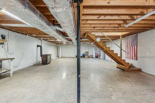 46 Seay Ln, Erin, TN 37061 - unfinished basement featuring concrete block wall, stairs, and water heater
