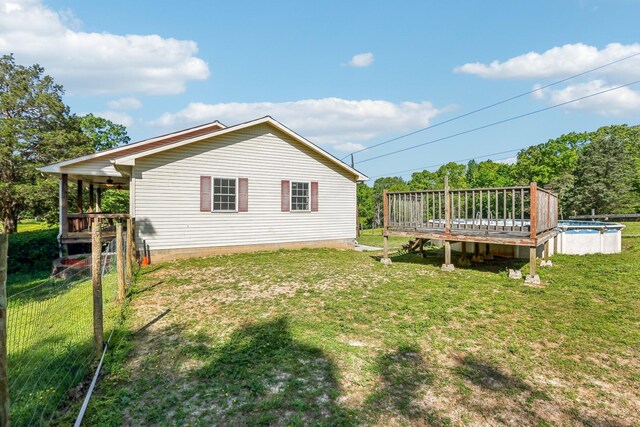 46 Seay Ln, Erin, TN 37061 - back of house with a yard, a wooden deck, and an outdoor pool