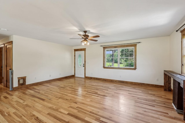 46 Seay Ln, Erin, TN 37061 - unfurnished living room with light wood-style flooring, a ceiling fan, and baseboards