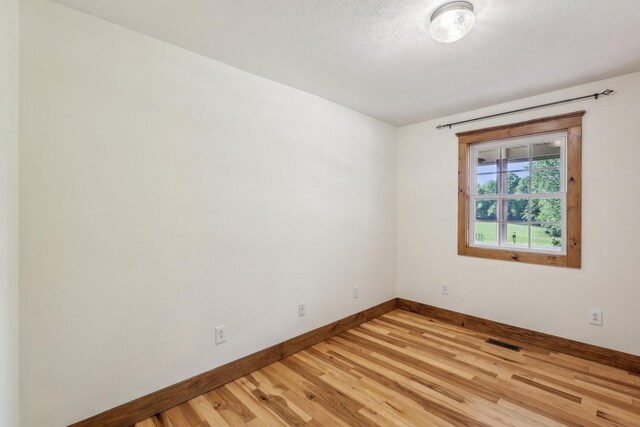 46 Seay Ln, Erin, TN 37061 - empty room featuring baseboards, light wood-style flooring, and a textured ceiling