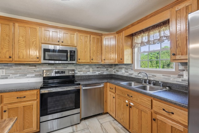 46 Seay Ln, Erin, TN 37061 - kitchen with stainless steel appliances, a sink, tasteful backsplash, dark countertops, and light tile patterned floors