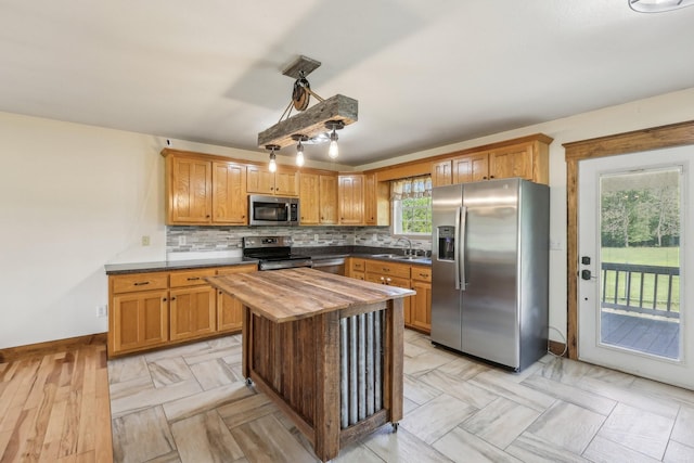 46 Seay Ln, Erin, TN 37061 - kitchen featuring stainless steel appliances, wooden counters, a sink, decorative backsplash, and baseboards