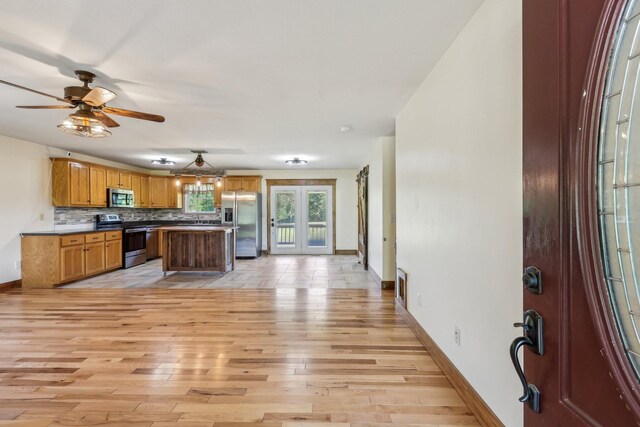 46 Seay Ln, Erin, TN 37061 - kitchen featuring appliances with stainless steel finishes, baseboards, a sink, and light wood finished floors