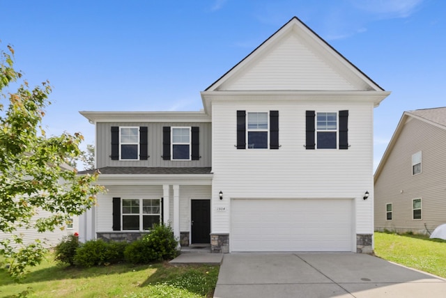 view of front of home featuring stone siding, an attached garage, a front lawn, driveway, and board and batten siding