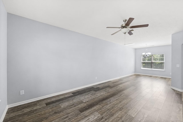 unfurnished room featuring a chandelier, wood finished floors, a ceiling fan, and baseboards