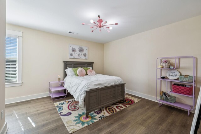 9015 Grayson Cir, Mount Juliet, TN 37122 - bedroom with wood finished floors, baseboards, and a chandelier