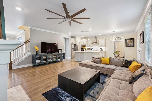 9015 Grayson Cir, Mount Juliet, TN 37122 - living area with light wood-style floors, ceiling fan, ornamental molding, stairway, and baseboards