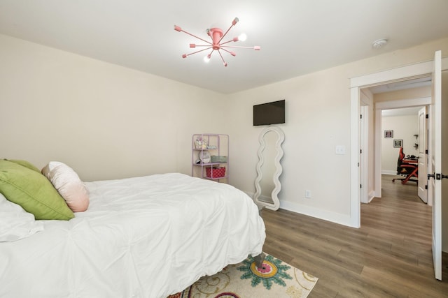 9015 Grayson Cir, Mount Juliet, TN 37122 - bedroom featuring wood finished floors, baseboards, and a chandelier