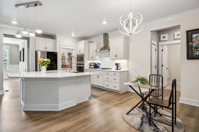 9015 Grayson Cir, Mount Juliet, TN 37122 - kitchen featuring appliances with stainless steel finishes, wall chimney exhaust hood, crown molding, tasteful backsplash, and white cabinetry