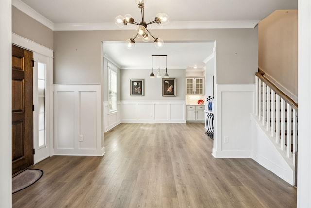 9015 Grayson Cir, Mount Juliet, TN 37122 - foyer entrance featuring ornamental molding, wainscoting, light wood finished floors, a chandelier, and a decorative wall