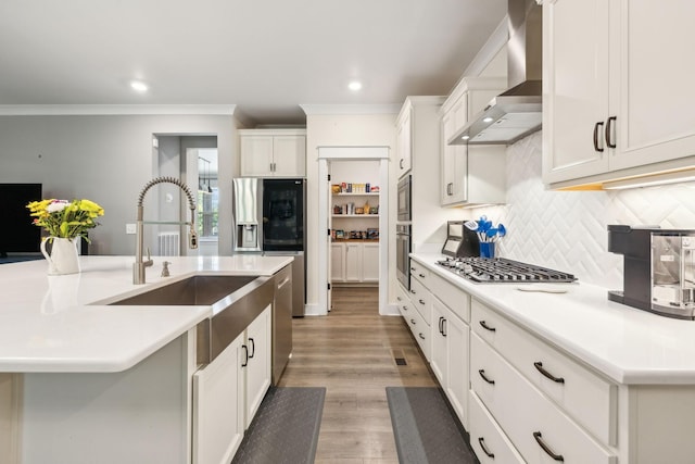 9015 Grayson Cir, Mount Juliet, TN 37122 - kitchen featuring wall chimney exhaust hood, crown molding, light wood-type flooring, light countertops, and tasteful backsplash