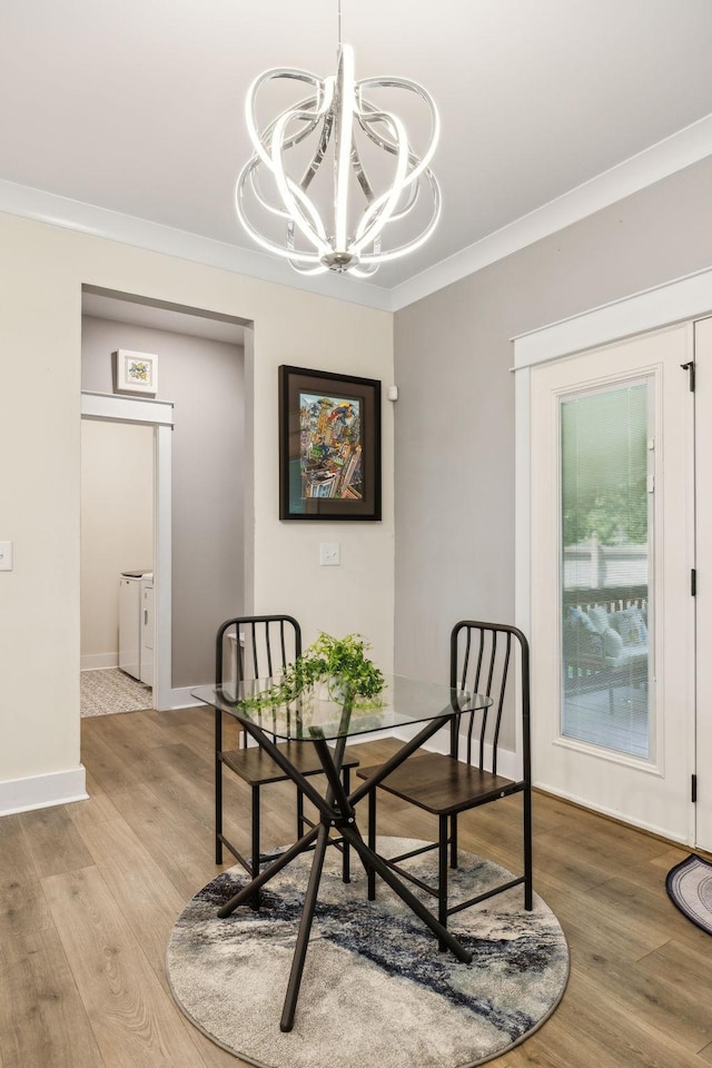 9015 Grayson Cir, Mount Juliet, TN 37122 - dining room featuring washer and clothes dryer, a chandelier, wood finished floors, crown molding, and baseboards