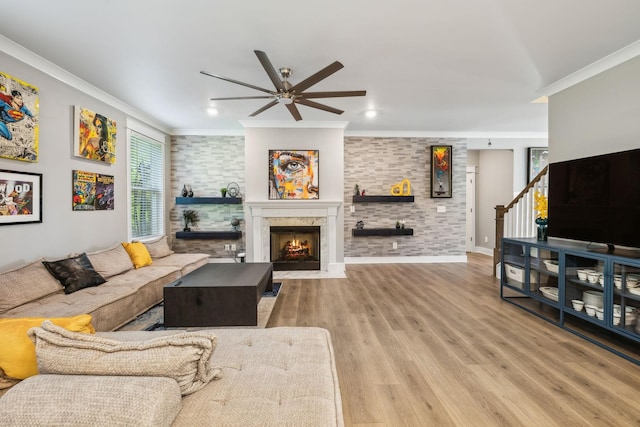9015 Grayson Cir, Mount Juliet, TN 37122 - living area with a ceiling fan, ornamental molding, a fireplace with flush hearth, wood finished floors, and stairway