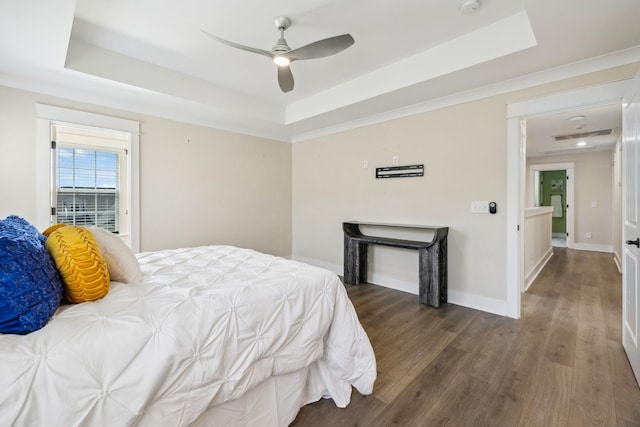 9015 Grayson Cir, Mount Juliet, TN 37122 - bedroom featuring a tray ceiling, wood finished floors, baseboards, and a ceiling fan