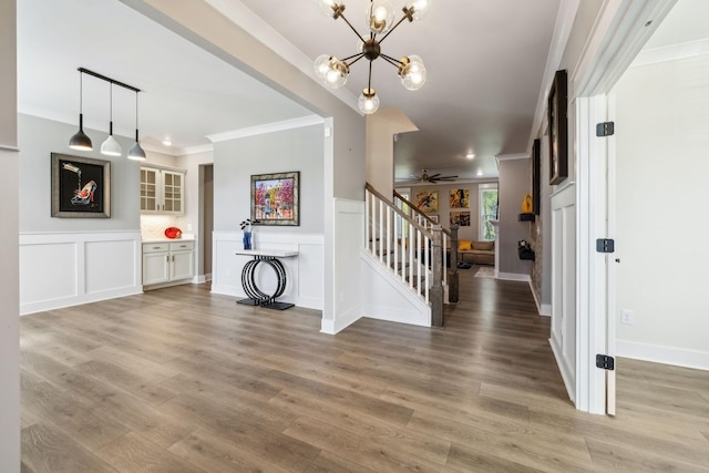 9015 Grayson Cir, Mount Juliet, TN 37122 - entryway with stairway, crown molding, light wood-style flooring, a decorative wall, and a chandelier