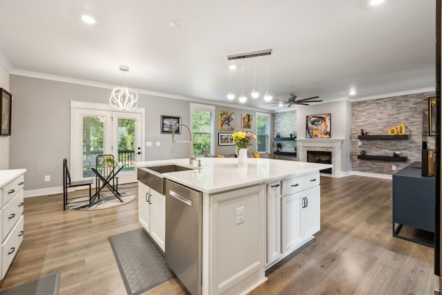 9015 Grayson Cir, Mount Juliet, TN 37122 - kitchen featuring dishwasher, a sink, ceiling fan, a fireplace, and light countertops