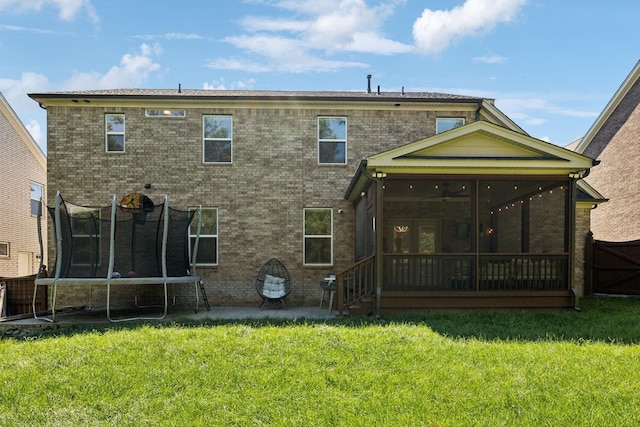 9015 Grayson Cir, Mount Juliet, TN 37122 - back of house featuring a trampoline, a sunroom, a yard, a patio area, and brick siding