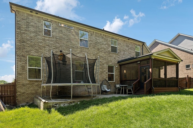 9015 Grayson Cir, Mount Juliet, TN 37122 - rear view of house featuring a trampoline, a sunroom, and brick siding