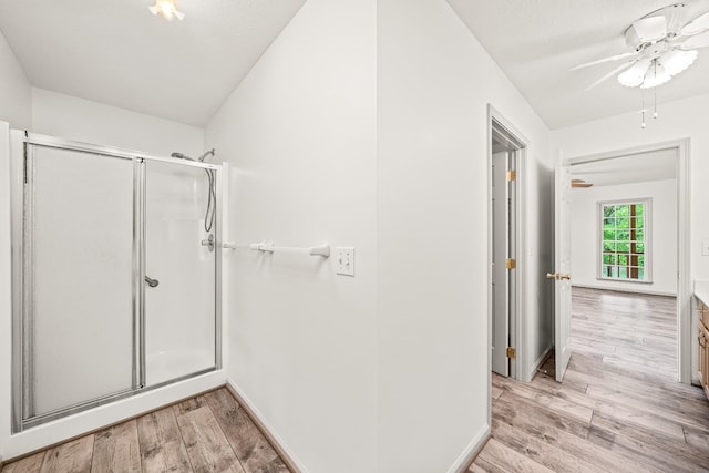 490 Luckey Ln, Sparta, TN 38583 - bathroom featuring a stall shower, wood finished floors, baseboards, and a ceiling fan