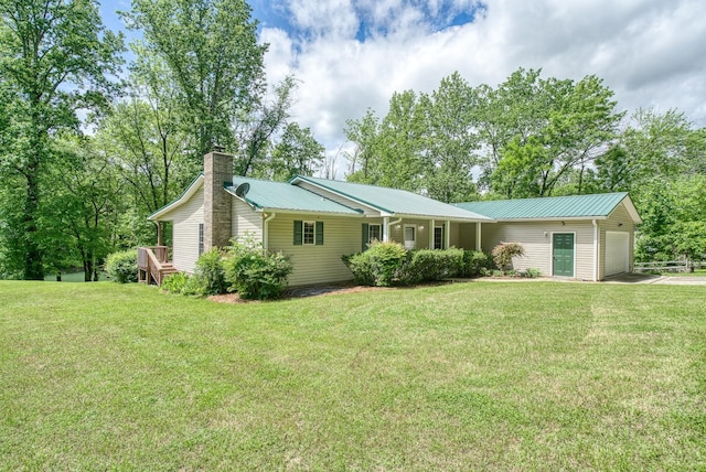 490 Luckey Ln, Sparta, TN 38583 - ranch-style house with a garage, driveway, a chimney, a front yard, and metal roof