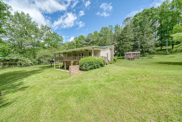 490 Luckey Ln, Sparta, TN 38583 - view of yard featuring a ceiling fan, an outdoor structure, and view of wooded area