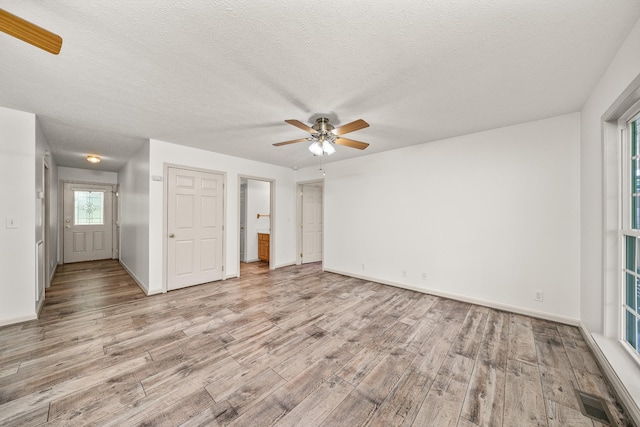 490 Luckey Ln, Sparta, TN 38583 - spare room featuring light wood-type flooring, ceiling fan, baseboards, and a textured ceiling