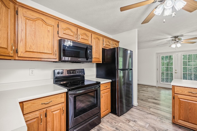 490 Luckey Ln, Sparta, TN 38583 - kitchen featuring stainless steel electric range, freestanding refrigerator, a ceiling fan, light countertops, and a textured ceiling