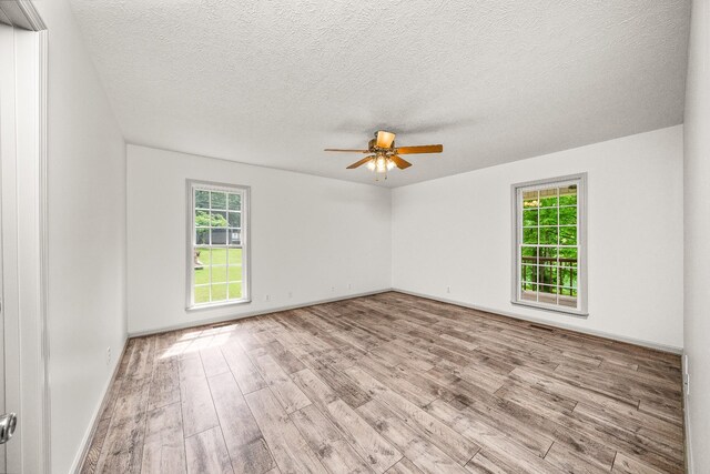 490 Luckey Ln, Sparta, TN 38583 - spare room featuring plenty of natural light, wood finished floors, ceiling fan, a textured ceiling, and baseboards
