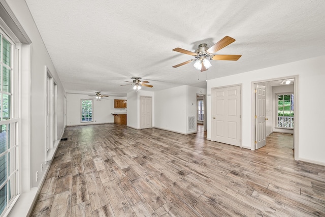 490 Luckey Ln, Sparta, TN 38583 - unfurnished living room with light wood finished floors, ceiling fan, a textured ceiling, and baseboards